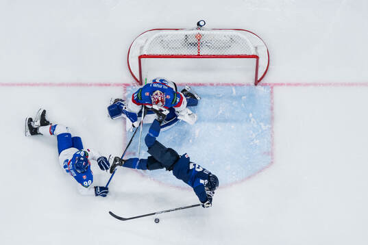 Andrej Golian and goaltender Samuel Hlavaj of Slovakia and