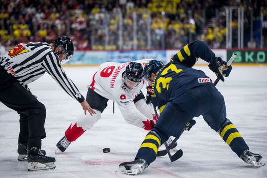 Nathan MacKinnon of Canada and Isac Lundeström of Sweden