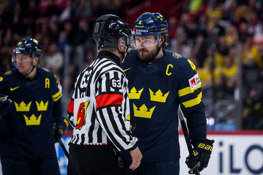 Referee Mikko Kaukokari and Rasmus Andersson of Sweden