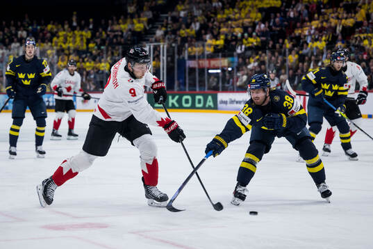 Nathan MacKinnon of Canada and Rasmus Sandin of Sweden
