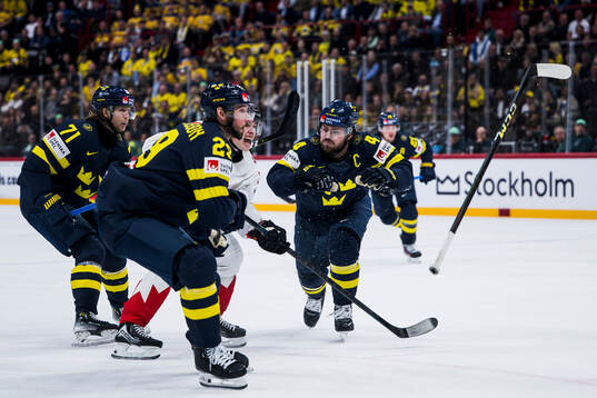 Travis Sanheim of Canada against Marcus Pettersson and