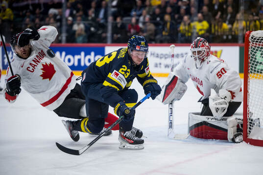 Lucas Raymond of Sweden and goaltender Jordan Binnington of
