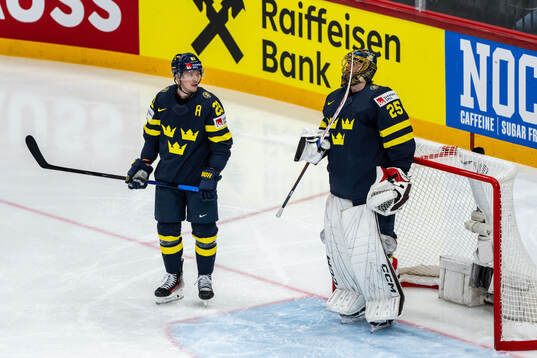 Lucas Raymond and goaltender Jacob Markström of Sweden