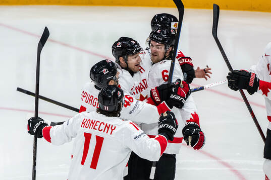 Nathan MacKinnon and Travis Sanheim of Canada celebrate