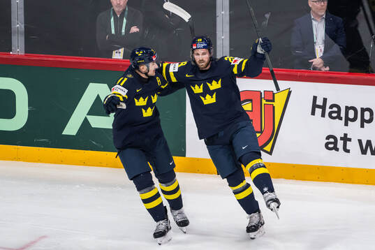 Mikael Backlund and Elias Lindholm of Sweden celebrate