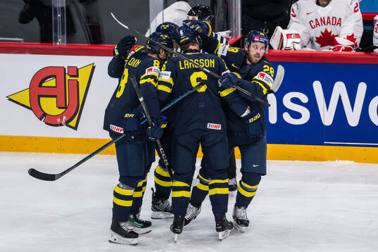 Elias Lindholm of Sweden celebrates with teammates