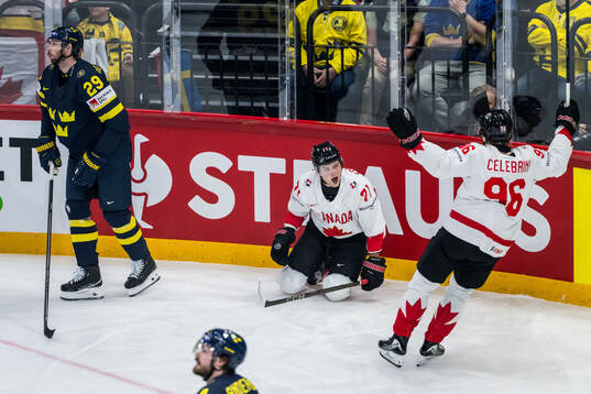 Tyson Foerster and Macklin Celebrini of Canada celebrate