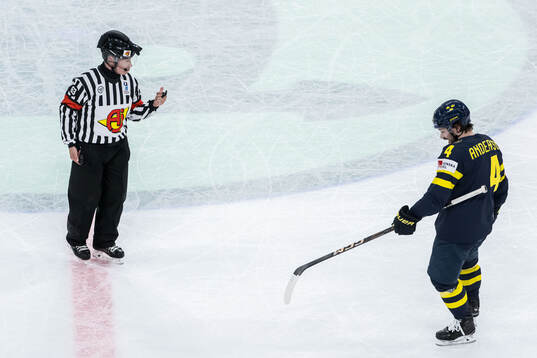 Referee Mikko Kaukokari and Rasmus Andersson of Sweden
