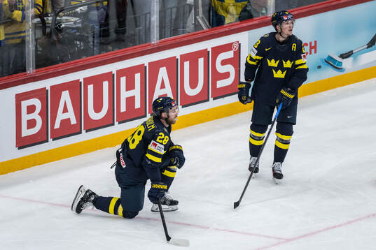 Elias Lindholm and Lucas Raymond of Sweden look dejected
