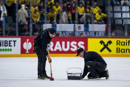 Blood is cleaned off the ice