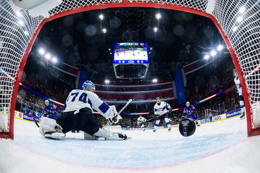 Shane Pinto of USA scores the 4-2 goal behind goaltender