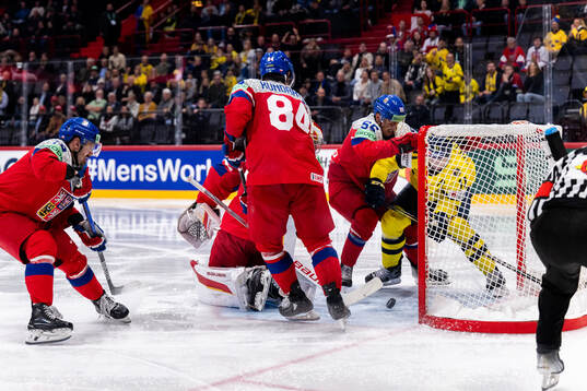 Mikael Backlund of Sweden and goaltender Dan Vladar, Tomas