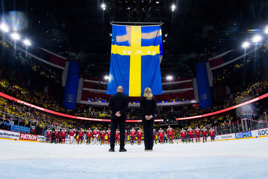 Players of Czech Republic see the Swedish flag being risen