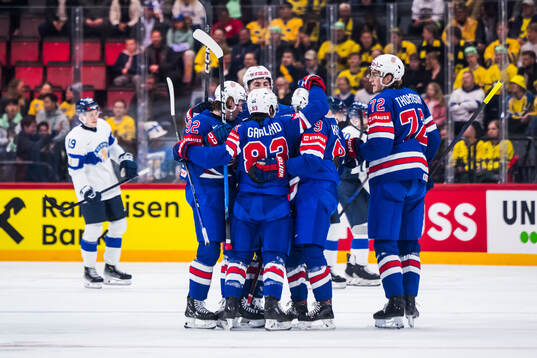 Conor Garland of USA celebrates with teammates