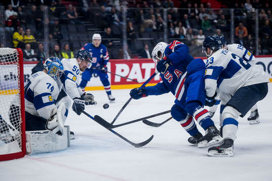 Conor Garland of USA scores 3-2 behind goaltender Juuse