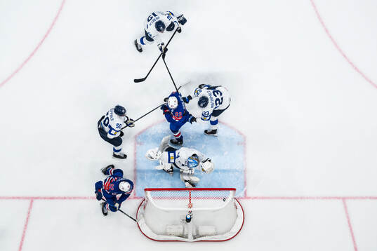 Conor Garland of USA scores 3-2 behind goaltender Juuse