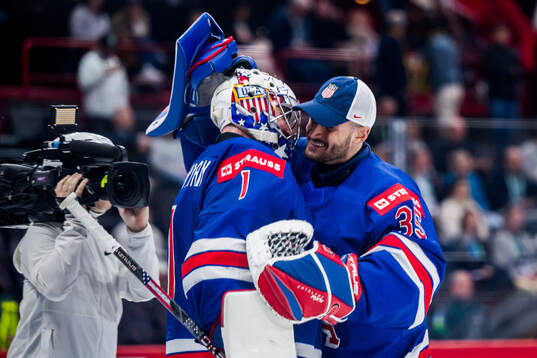 Jeremy Swayman and Joey Daccord of USA celebrating