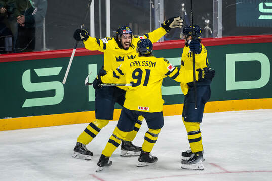 Mika Zibanejad and Leo Carlsson of Sweden celebrate