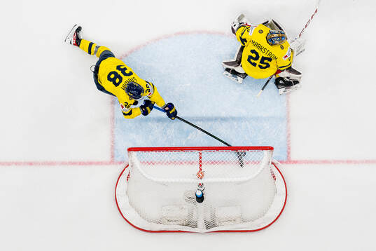 Rasmus Sandin with a save behind goaltender Jacob