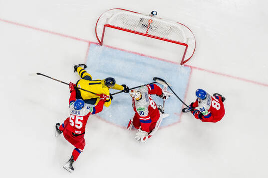 Mikael Backlund of Sweden against Libor Hajek , goaltender