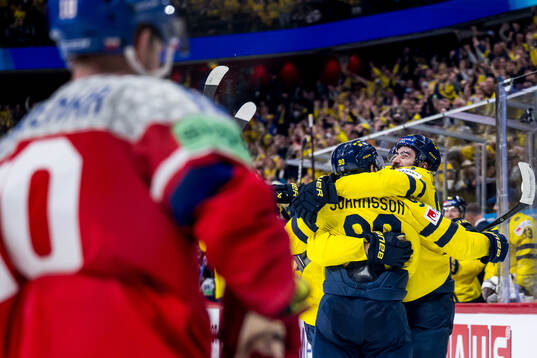 Mika Zibanejad and Marcus Johansson celebrate with Leo