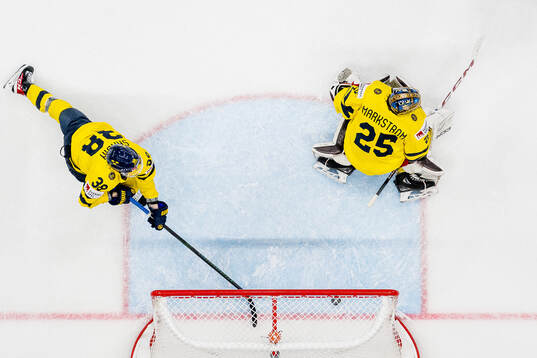 Rasmus Sandin with a save behind goaltender Jacob
