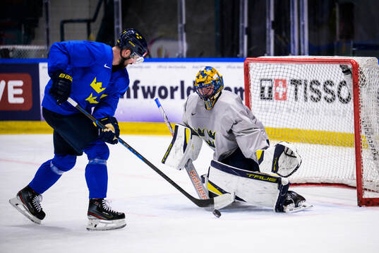 Erik Gustafsson and goaltender Samuel Ersson of Sweden at a