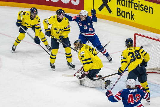 Shane Pinto and Will Smith of USA celebrate and goaltender
