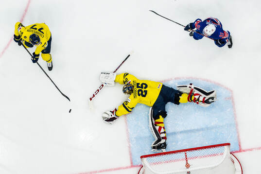 Simon Edvinsson and goaltender Jacob Markström of Sweden
