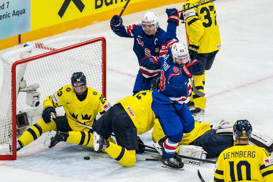 Clayton Keller and Conor Garland of USA celebrate