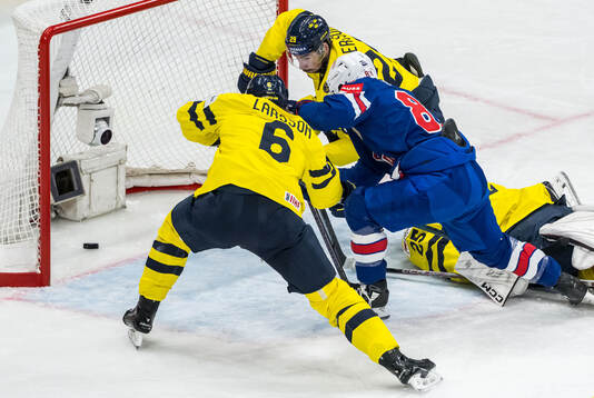 Conor Garland of USA scores 0-3 behind goaltender Jacob