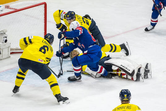 Conor Garland of USA scores 0-3 behind goaltender Jacob
