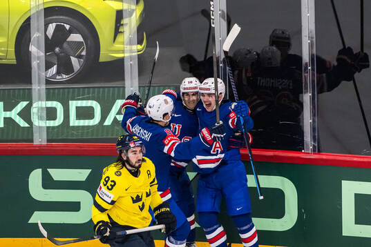 Zach Werenski, Matty Beniers and Michael Eyssimont of USA