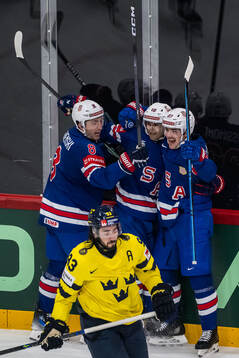 Zach Werenski, Matty Beniers, and Michael Eyssimont of USA