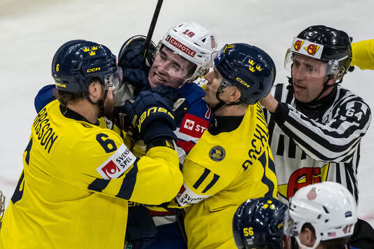 Adam Larsson and Mikael Backlund of Sweden against Drew