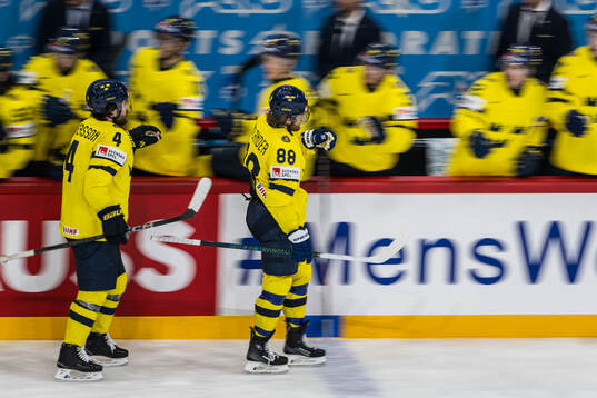 Rasmus Andersson and William Nylander of Sweden celebrate
