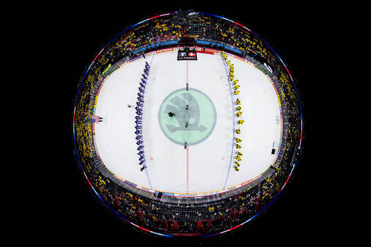 Players of USA and Sweden watch the American flag being