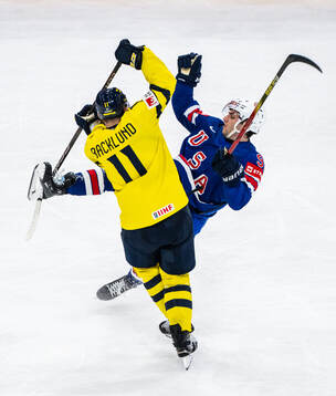 Mikael Backlund of Sweden tackles Frank Nazar of USA