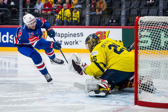 Shane Pinto of USA and goaltender Jacob Markström of Sweden