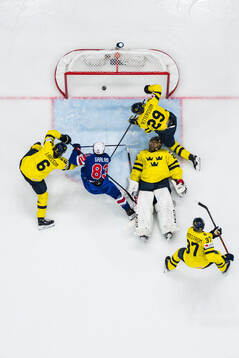 Conor Garland of USA scores 0-3 behind goaltender Jacob