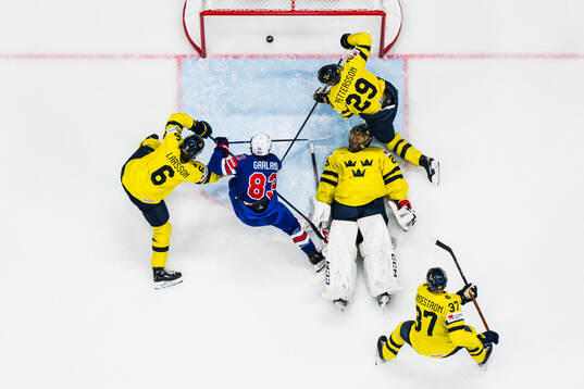 Conor Garland of USA scores the 0-3 goal behind goaltender