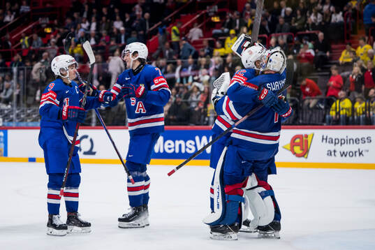 Goaltender Jeremy Swayman of USA celebrates with team mates