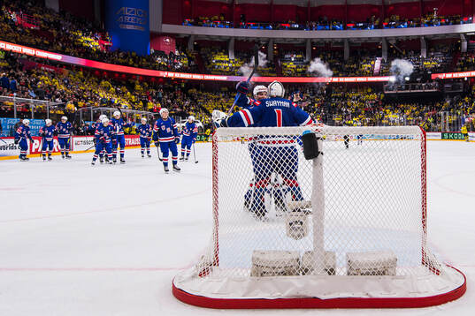 Goaltender Jeremy Swayman of USA celebrate with teammates