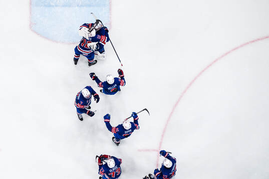 Goaltender Jeremy Swayman of USA celebrate with teammates