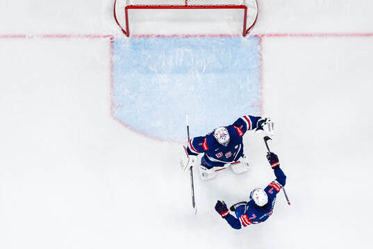 Goaltender Jeremy Swayman and Michael Kesselring of USA