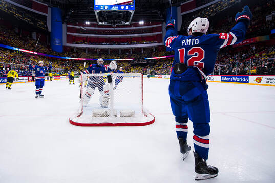 Shane Pinto of USA celebrate the 2-6 goal with goaltender