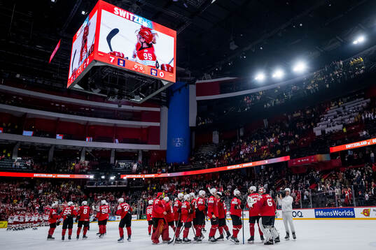 Leonardo Genoni of Switzerland celebrates with teammates
