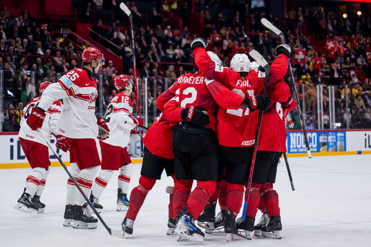 Nino Niederreiter of Switzerland celebrates with team mates