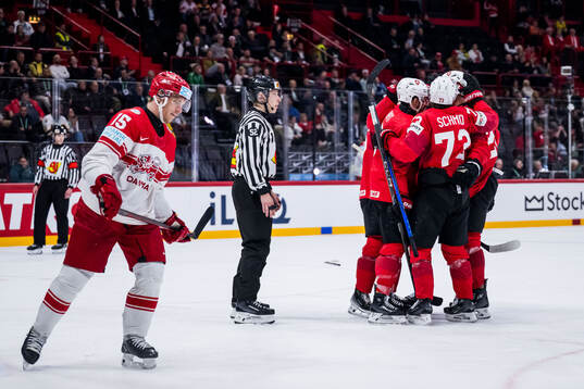 Tyler Moy of Switzerland celebarates with team mates and