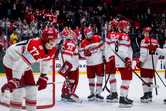 Goaltender Sebastian Dahm of Denmark looks dejected
